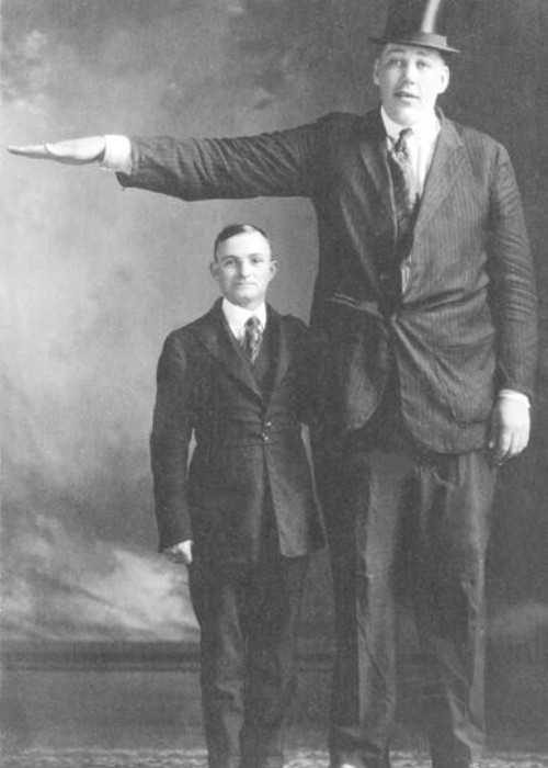A Photo of Actor John Aasen Standing Next to a Normal Sized Man