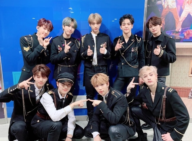 All the 'Stray Kids' members as seen while posing for a group picture in 2018