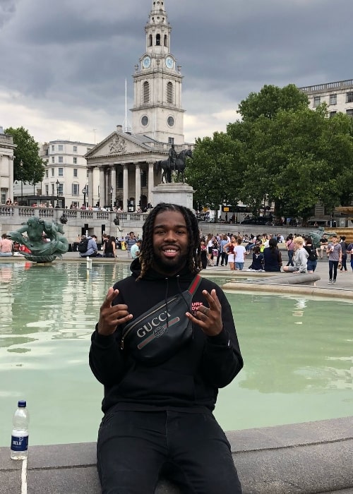 Iamsu! smiling for a picture in London, United Kingdom in July 2018