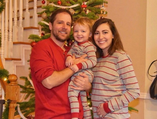 Taylor Dooley as seen while posing for a family Christmas picture along with her husband, Justin Cassotta, and their son in December 2018